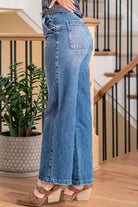 KanCan Jeans   Ultra High Rise 90s Wide Leg Jeans, a nod to the iconic '90s style. While they feature a rigid stretchiness level, these jeans offer a unique design with a hidden button fly, a dart on the back waist, and front slant pockets. The one-inch wide hem adds a trendy twist to complete the look. Color: Dark Wash Cut: FIT, 30" Inseam* Rise:-Rise, 11 1/2" Front Rise* Material: 100% Cotton, Rigid Stitching: Classic Fly: Button Fly Style #: KC7948D