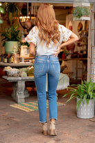 Vervet Flying Monkey Jeans  These mid-waisted straight-leg jeans have a soft stretch material that will feel so comfortable. With a distressed leg, style with a front tuck and flats for a casual look.  Color: Medium Blue Wash  Cut: Straight, 27* Rise: Mid Rise, 9" Front Rise* Material: 90.5%COTTON, 7.5%POLYESTER, 2%SPANDEX Machine Wash Separately In Cold Water Stitching: Classic Fly: Zipper Style #: V2418 Contact us for any additional measurements or sizing. 