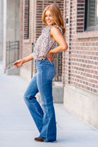 Flying Monkey Jeans  With comfortable stretch denim a fray hemline, these high-waisted and relaxed flares move with you. Features a cross-over button waistband and bell-bottom-styled legs.  Wash: Dark Blue Cut: Flare, 34" Inseam* Rise: High Rise, 11" Front Rise* 93% COTTON 5% POLYESTER 2% SPANDEX Stitching: Classic Fly: Zip Style #: F4511 Contact us for any additional measurements or sizing. 