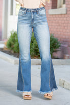 KanCan Jeans  KanCan Stretchy  Flare, 33.5" Inseam* High Rise, 10" Front Rise* Dark Blue Wash  93% COTTON, 5% POLYESTER, 2% SPANDEX Fly: Zipper Fly Style #: KC9324M Contact us for any additional measurements or sizing.    *Measured on the smallest size, measurements may vary by size.   Cas is 5'7" and wears a size 25 in jeans, a small in tops, and 8 in shoes. She is wearing size 25 in these jeans. 