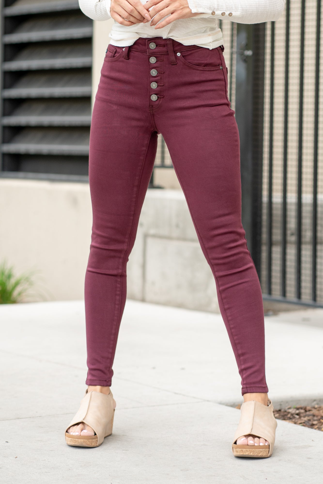 KanCan Jeans Color: Burgundy Red Cut: Super Skinny, 29" Inseam* Rise: High-Rise, 10" Front Rise* 57% COTTON, 35% MODAL, 6% POLYESTER, 2% SPANDEX Stitching: Classic Fly: Exposed Button Fly  Style #: KC9252BG Contact us for any additional measurements or sizing.    *Measured on the smallest size, measurements may vary by size.   Alyssa wears a size 25 in jeans, a small in tops, and 8 in shoes. She is wearing size 25 in these jeans. 