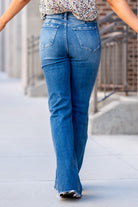 Flying Monkey Jeans  With comfortable stretch denim a fray hemline, these high-waisted and relaxed flares move with you. Features a cross-over button waistband and bell-bottom-styled legs.  Wash: Dark Blue Cut: Flare, 34" Inseam* Rise: High Rise, 11" Front Rise* 93% COTTON 5% POLYESTER 2% SPANDEX Stitching: Classic Fly: Zip Style #: F4511 Contact us for any additional measurements or sizing. 