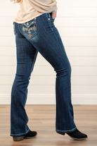 Miss Me  Wear these cross pockets jeans every day to bling up your wardrobe. Boot cut jeans featuring a 5 pocket design, whiskering, and crystal rivets. Wash: Dark Blue Inseam: 34" Boot Cut* Mid Rise, 8.75" Front Rise* Silver Buttons and Rivets  Material: 98% Cotton 2% Elastane Style #: M3824B   Contact us for any additional measurements or sizing.    *Measured on the smallest size, measurements may vary by size.  