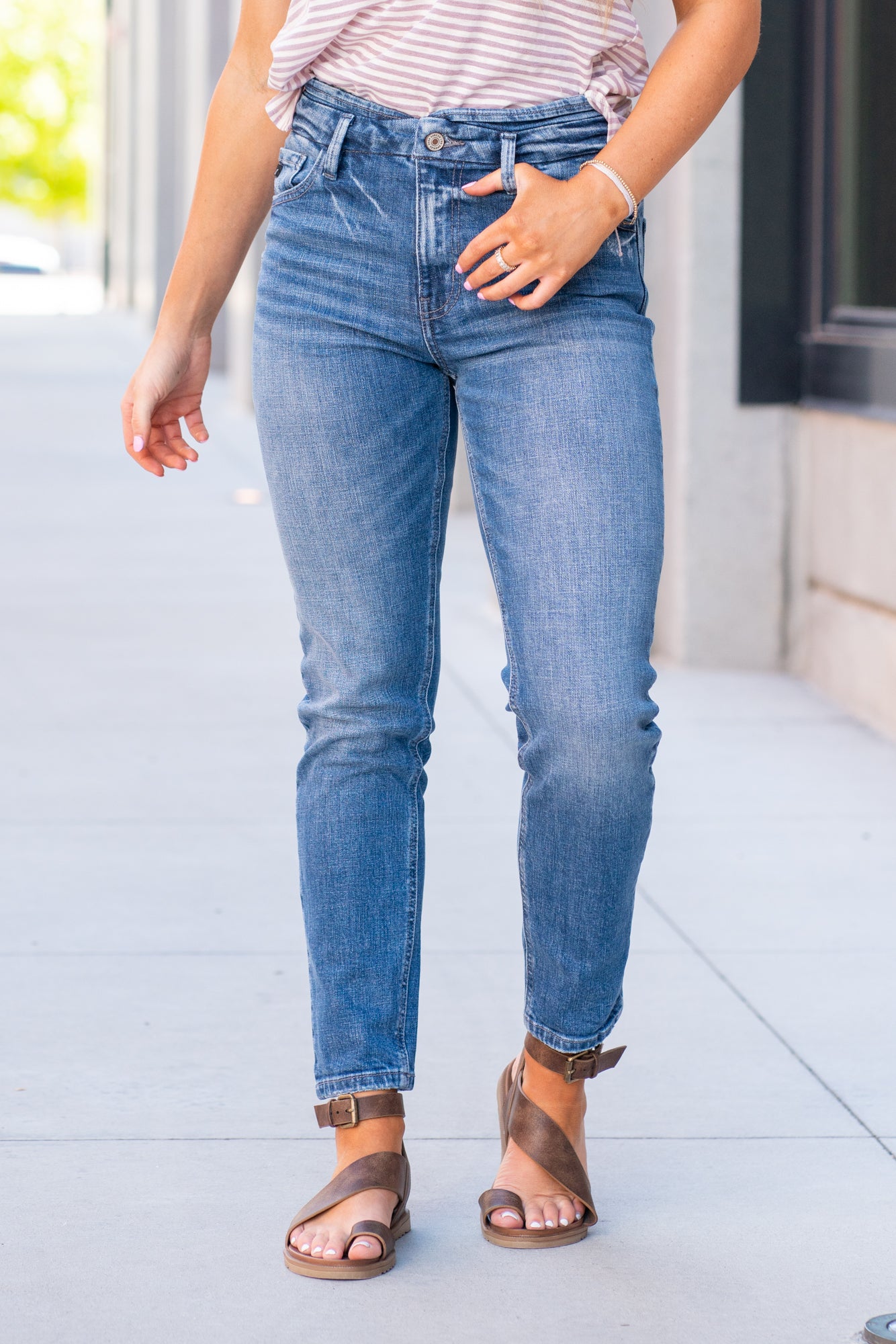 KanCan Jeans  With a high waist and mom fit, these will be your go-to jeans that will never go out of style. Color: Medium Blue  Cut: Mom Fit, 28" Inseam* Rise: High-Rise, 10.5" Front Rise* 98% Cotton 2% Spandex  Fly: Zipper Style #: KC8671M Contact us for any additional measurements or sizing.  *Measured on the smallest size, measurements may vary by size.