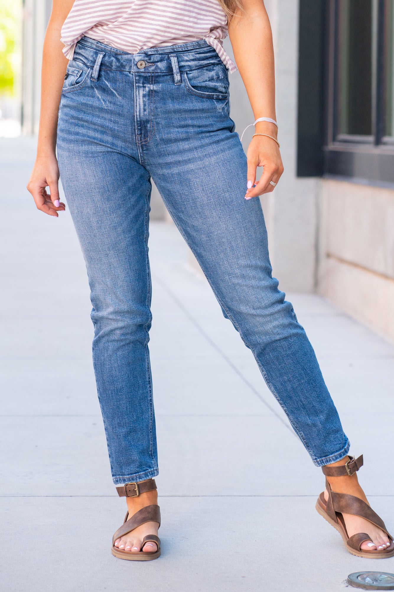 KanCan Jeans  With a high waist and mom fit, these will be your go-to jeans that will never go out of style. Color: Medium Blue  Cut: Mom Fit, 28" Inseam* Rise: High-Rise, 10.5" Front Rise* 98% Cotton 2% Spandex  Fly: Zipper Style #: KC8671M Contact us for any additional measurements or sizing.  *Measured on the smallest size, measurements may vary by size.