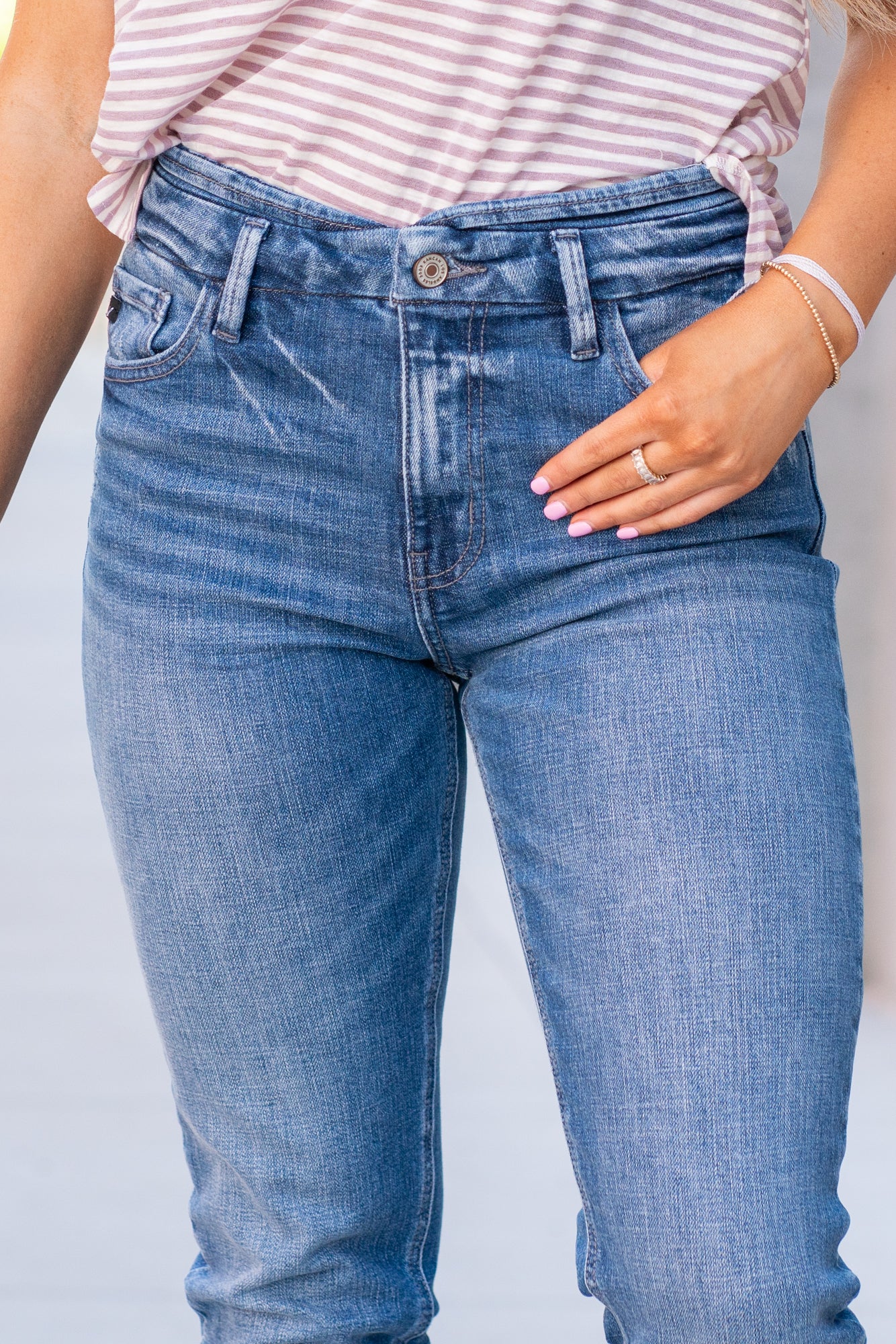 KanCan Jeans  With a high waist and mom fit, these will be your go-to jeans that will never go out of style. Color: Medium Blue  Cut: Mom Fit, 28" Inseam* Rise: High-Rise, 10.5" Front Rise* 98% Cotton 2% Spandex  Fly: Zipper Style #: KC8671M Contact us for any additional measurements or sizing.  *Measured on the smallest size, measurements may vary by size.