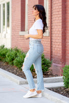 Cello Jeans  Beautifully balanced, these mom jeans offer a soft 100% cotton material with a cross-over button closure. Their destructed detailing and light blue wash make them a must-have.  Color: Light Blue Wash Cut: Slim Straight Fit, 28" Inseam Rise: High-Rise, 10.5" Front Rise 100% Cotton Fly: Zipper Style #: WV17818M-LTD Contact us for any additional measurements or sizing.